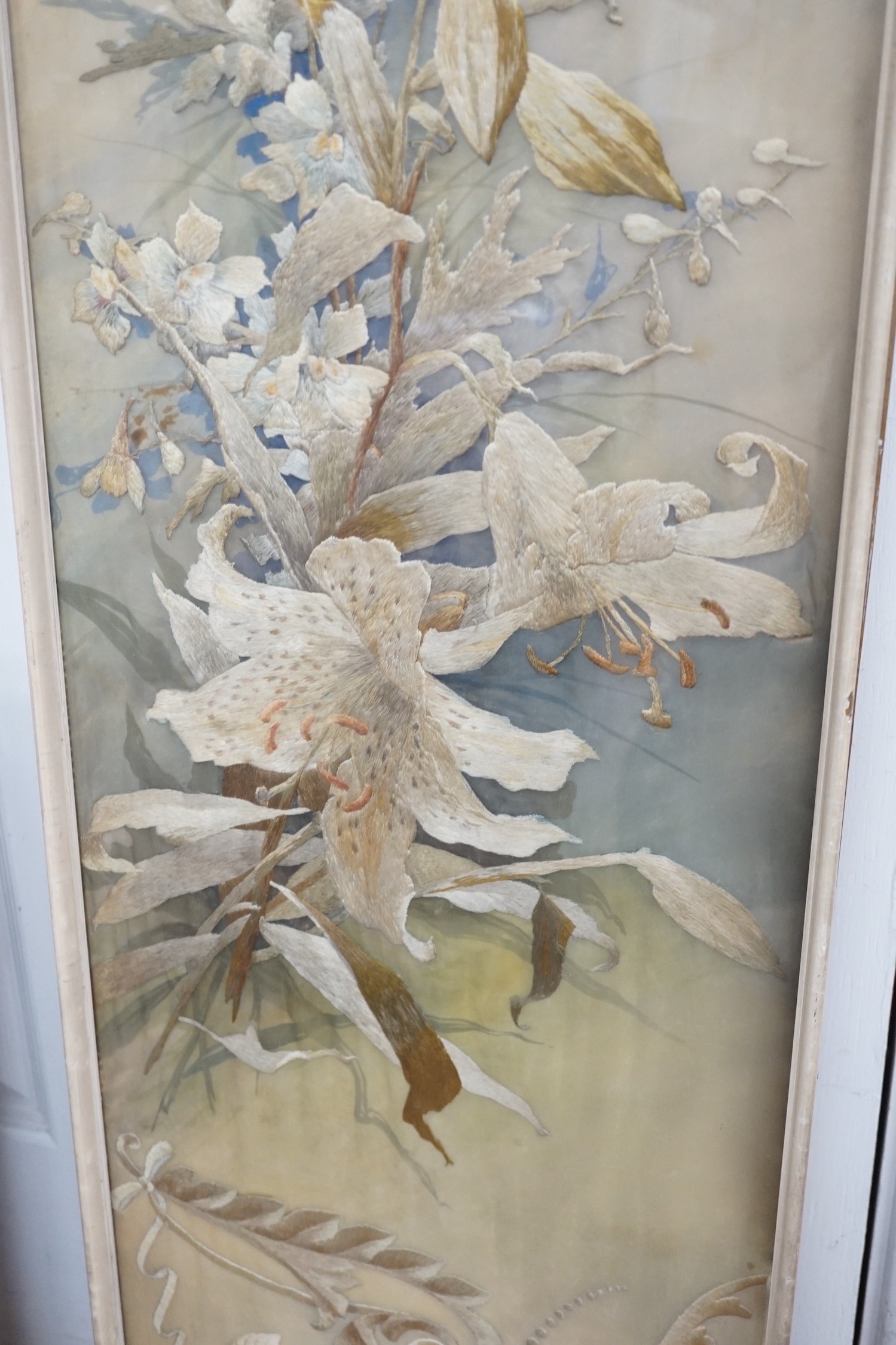 A framed silk embroidered panel, possibly French, cut from a larger piece, 137cms high x 27wide